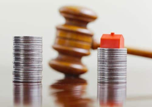 stacks of coins with a gavel in the background showing the concept of division of assets in a divorce