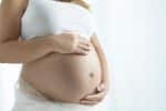 Pregnant woman cradling belly - surrogacy in south carolina concept